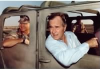 George H.W. Bush riding in a Humvee with General Schwarzkopf