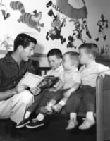 Johnny Carson reading a story with his three sons, 1955