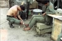 CPT Gary Lattimer MD taking care of a soldier'd ingrown toenail, 1968