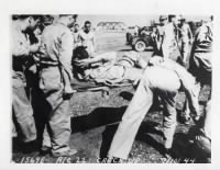 Lee J Humphrey-crash landing 1944-Lee on stretcher.jpg
