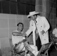 Billy Cannon, left in the dressing room as he receives thanks from the Houston Oilers owner, Bud Adams, in Houston, Texas, Jan. 1, 1960..JPG