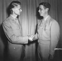 Brigadier General James McCormack, Jr, (right) is congratulated by Major General Lauris Norstad (left) after being presented with the oak leaf cluster to his Legion of Merit.jpeg