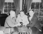 640px-Photograph_of_President_Truman_at_his_desk_in_the_Oval_Office,_receiving_his_annual_pass_to_National_Football_League..._-_NARA_-_200160.jpg