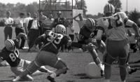 1962_TrainingCamp  Ken Iman-53 reaches out to tackle running back Paul Dudley-22.jpg
