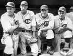 Larry French, from left, Lon Warneke, Bill Lee and Charlie Root look on from the dugout before a September 1935 game at Wrigley Field in Chicago.jpg