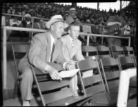 Chicago Cubs Vice President Charlie Grimm, left, and Bill Wrigley watch a ball game together from the stands at Wrigley Field on June 17, 1949..jpg