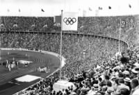 The Olympic Flag flying next to the Personal standard of Adolf Hitler over the Olympic Stadium, Berlin 1936.jpg