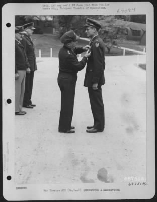 Awards > 1St Lt. Richard W. Booze Is Presented The Distinguished Flying Cross By Lt. General Lewis H. Brereton.  Brig. General Vic H. Strahm And Brig. Gen. Otto P. Weyland Stand In The Background.  31 May 1944, England.