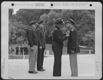 Awards > Colonel George R. Bickell Is Presented The Distinguished Flying Cross By Lt. General Lewis H. Brereton.  Brig. General Vic H. Strahm And Brig. Gen. Otto P. Weyland Stand In The Background.  31 May 1944, England.