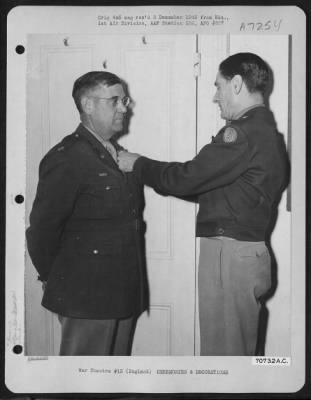 Awards > Lt. Col Brown, Attached To Hdq., 1St Bomb Division, Receives An Award From Brig. General Bartlett Beaman During A Ceremony On 19 June 1945 At An 8Th Air Force Base In England.