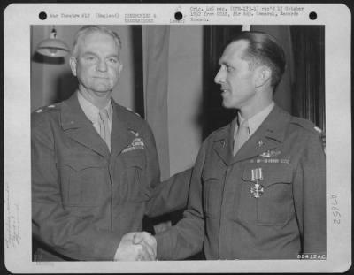 Awards > Lt. Colonel Burton R. Baldwin Of The 9Th Troop Carrier Command Is Congratulated By Major General Paul L. Williams After Receiving The Dfc At A Ceremony At An Airbase Somewhere In England.  3 May 1945.