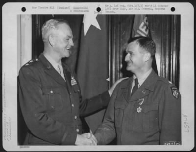 Awards > Lt. Colonel Burbridge Is Congratulated By Major General Paul L. Williams Of The 9Th Troop Carrier Command, During A Ceremony Somewhere In England.  2 June 1945.