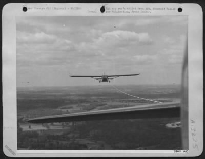 General > A troop carrying glider of the 9th Air force skims over the English country side at the end of a towline attached to a Douglas C-47 of the Troop Carrier Command during maneuvers prior to the invasion of Europe. Gliders are expected to play an