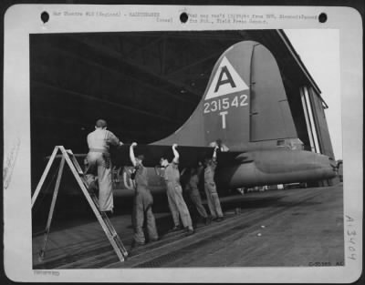 Thumbnail for General > Ground crew is shown installing new elevator to horizontal stabilizer damaged by flak over Germany. ENGLAND.