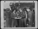 Capt. Walter Stewart, Salt Lake City, Utah, Pilot Of The Consoldiated B-24 'Liberator' Bomber, 'Bomerang' Which Has Completed 53 Missions In The European Theatre Of Operations, Receives A Cake From Miss Rachel Homer, American Red Cross Worker, Prior To De - Page 1