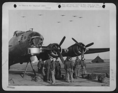 Consolidated > ENGLAND-After bombing Berlin, the capital of the German war machine, Boeing B-17 Flying ofrtresses of the U.S. 8th Air force circle at their base in England, preparatory to landing, while on the ground the crew of one of the ofrts that hassalready