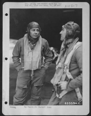 General > Colonel Harold W. Bowman, Commanding Officer Of The 401St Bomb Group, Discusses The Bombing Attack On Enemy Installations At Caen, France, With Lt. Causey, England, 9 February 1944.