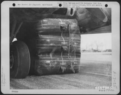 Thumbnail for General > Large Rubber Lift Bags Are Used To Aid In Jacking Up A Boeing B-17 "Flying Fortress" Whose Landing Gear Has Collapsed.  The Lift Bags Are Rolled Beneath The Wing And Inflated Until The Necessary Pressure Is Exerted To Raise The Wing.  Rubber Was Chose As