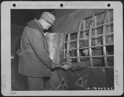 Thumbnail for General > Cpl. Leo Birks Of Riverside, Iowa (Outside Plane) And T/Sgt. William F. Fields Of Surrency, Georgia Remove Sheet Aluminum From The Side Of A Boeing B-17 Which Had Been Damaged In Action.  Warton, England.  23 March 1943.