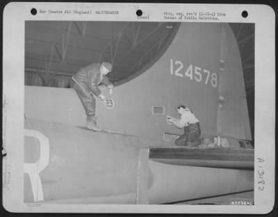 Thumbnail for General > 8Th Bomber Command Ground Crew Members Study And Repair Flak Damaged Tail Of Boeing B-17 "Flying Fortress" At An Air Base Somewhere In England.