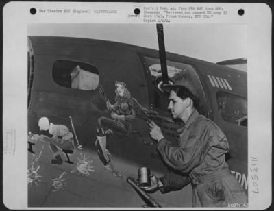 Painting & Washing > England-Cpl. Wm. Naville, of New Albany, Ind., puts the finishing touches on a voluptous girl on the nose of a Boeing B-17 Flying ofrtress named "Dame Satan." Naville studied commercial and fine art for nine years.