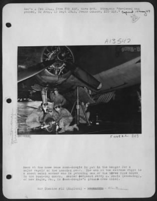 Thumbnail for Tires & Wheels > Back at the home base Bomb-Boogie is put in the hangar for a major repair of the landing gear. The man at the extreme right is a sheet metal worker who is patching one of the three flak holes in the bomb-bay doors. Master Sergeant Jerry Z. Docis