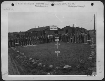 Thumbnail for General > Soldiers at an 8th Fighter Command base in England "queu up" to buy U.S. WarBonds to help finance a $6,000,000 "Victory Squadron" of fighter planes to be purchased entirely by personnel of the 8th Air force. ofrming an inverted V-ofr-Victory, the