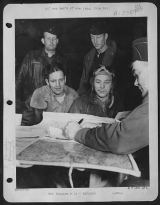 General > HIS TOUR OF MISSIONS COMPLETED: 1st Lt. Leroy Faringer (wearing goggles) sits for final interrogation on his return from a bombing mission over northwest Germany on 22 Dec. Lt. Faringer, 27, of Texarkana, Texas, is navigator of ofrtress "Demo
