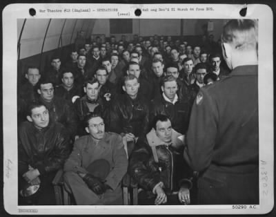 Thumbnail for General > Early morning. Commanding Officer Col. Claude E. Putnam, of Jaxboro, Tex., (back to camera) gives the pilots, co-pilots, navigators and bombardiers their instructions for attack. Intense concentration on the job ahead of them marks the faces of these