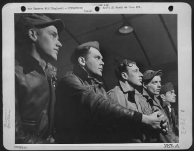 General > Camera study of gunner's at morning's briefing. Their faces show intentness and concentration as they prepare for what may be the biggest assignment of their lives. They are serious, purposeful and they know what is in store for the targets they hit