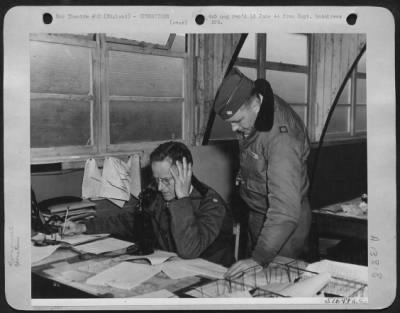 Thumbnail for General > Two Midwesterners vital to the success of the European Invasion are shown above in the Combat Operations-Intelligence office at an Eighth AAF Fighter Station in England. Maj. Alfred W. Craven, Jr., (seated), Chief Intelligence Officer from 528