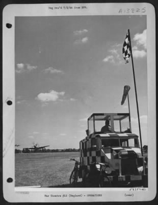 Thumbnail for General > With some of the P-51 Mustang fighters just about to set their wheels down on their English based station and still other returning ships circling the field, the boys in the mobile flying control van stand by to guide the planes in to a safe landing.