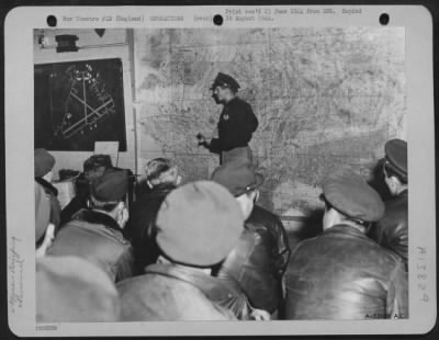 General > 1st Lt. William H. Buchanan of Ann Arbor, Michigan, weather officer, briefs combat crews on the weather to be expected on their next mission from an 8th Air force base in England.