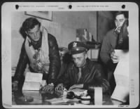 Lt. Ralph K. Hover, Salem, Mo., gets last minute instructions from his intelligence officer, Lt. Charles Ashcroft, of Pittsburgh, Pa., for the 21 June 44 long range fighter escort mission with bombers of the 8th Air force which attacked targets in - Page 1