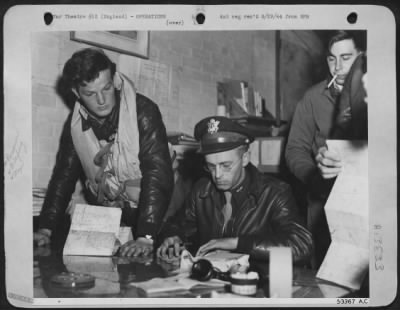 General > Lt. Ralph K. Hover, Salem, Mo., gets last minute instructions from his intelligence officer, Lt. Charles Ashcroft, of Pittsburgh, Pa., for the 21 June 44 long range fighter escort mission with bombers of the 8th Air force which attacked targets in