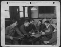 ENGLAND-uponn returning from a mission over enemy occupied territory, these 8th Air force P-51 Mustang pilots have gone directly to the intelligence section to be interrogated. Giving their informationto the interrogation officer, they are left to - Page 1