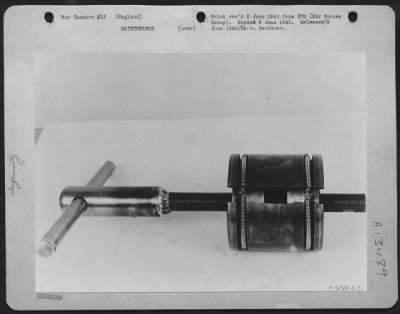 Miscellaneous > A Field Coil Pole-Shoe Expander Devised And Constructed By T/Sgt. James W. Turner Of East Point, Ga., And S/Sgt. Levere M. Holmes Of Ogden, Utah, Enables Soldier-Technicians At An Air Service Command Depot In England, To Install New Field Coils In Repaire