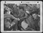 Thumbnail for A Friendly Handshake Welcomes These 14 Nurses And 17 Men, Members Of The Air Evac Unit Missing For Two Months When Their Plane Was Forced Down In Albania Enroute To Bari From Sicily. - Page 1