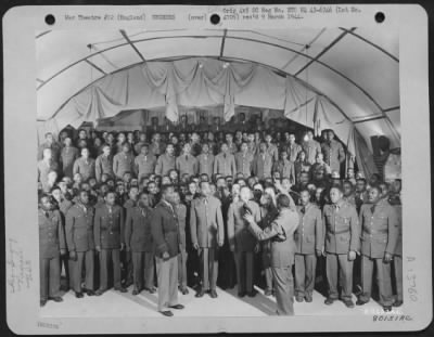 General > A Negro Choir, Composed Of Volunteers From The 827Th, 829Th, 847Th Aviation Engineer Battalions At Eye, England, Rehearse Under The Direction Of F/Sgt. Alexander B. Jordan Of St. Paul, Minn., While Chaplain William M. Perkins Listens.  1 September 1943.