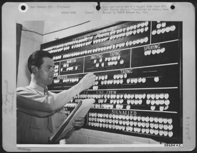 General > Re-Deployment - Fighter Planes...Each White Disc Represents An Airplane Moving Through The Re-Deployment Center At Speke, England.  Sgt. Joe M. Hayes, Of Springfield, Mo., Moves A Plane From 'Awaiting Taping' To 'Taping' On This Central Control Board Whic