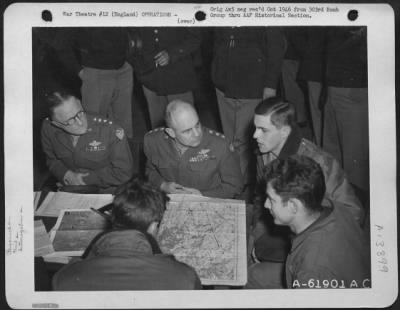 General > General Carl Spaatz And Lt. General Jimmy Doolittle Discuss Results Of Bombing Raid On Oil Refinery At Halle, Germany, With Crews Who Participated In The Mission.  303Rd Bomb Group, England.  31 March 1945.