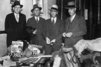 Sheriff Smoot Schmid (dark suit), Deputies Ed Caster. Ted Hinton and Bob Alcorn (far right).jpg