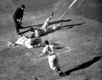 Roy Partee slides home with a run past a diving St. Louis Cardinals catch Joe Garagiola.jpg