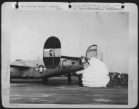 PARACHUTE BRAKES-When its hydraulic system had been shot out during a U.S. Army 8th Air force raid over Germany, this Consolidated B-24 Liberator bomber had to use parachutes for brakes to land at its base in England. Fastened to the interior of the - Page 1
