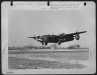 An 8th AF Consolidated B-24 Liberator of the 448th Bomb Group, comes in for a landing at its base in England after completing bombing mission to Swinemunde, Germany docks in support of Russian troops advancing in Eastern Front. - Page 1