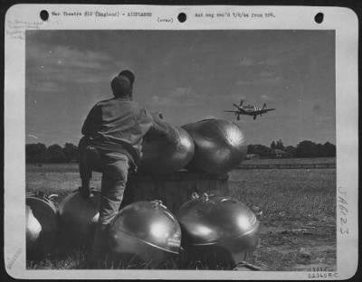 Thumbnail for Consolidated > Crew chief leaning on auxiliary fuel tanks anxiously sweats about his pilot and ship. 376 Fighter Squadron, 361st Fighter Group