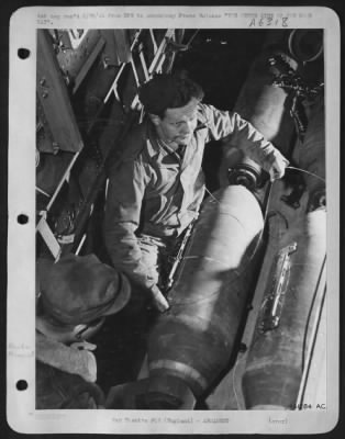 Thumbnail for General > You are looking down from the radio room through the bomb bay of a U.S. Army 8th A.F. bomber. A couple of USAAF ordnance men are preparing two 500-lb high explosive bombs which are still on the bomb cart before being lifted into position and fixed