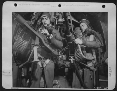 General > Left to right: S/Sgt. Wm. L. Adair, Consolidated B-24 Liberator gunner, of Degroff, Ohio, and S/Sgt. Billie McClennen, right waist gunner, of Comanche, Oklahoma, are shown preparing guns to be swung out into waist positions.