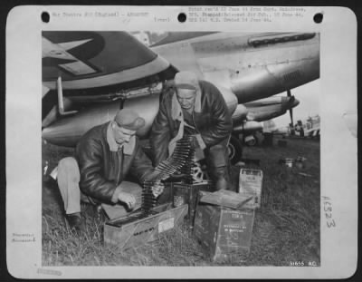 General > Two armorers prepare the sting of an Eighth Fighter Command North American P-51 Mustang fighter before the airplane takes off on another of the around-the-clock missions that have been the order of the day since the invasion. The 50 caliber bullets