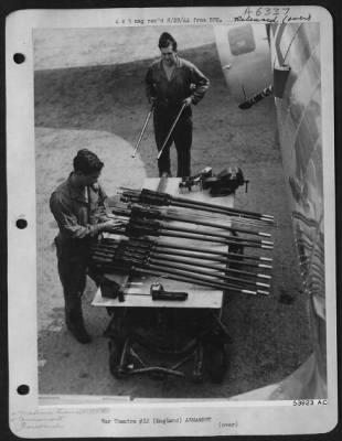 Thumbnail for General > GUN CLEANING-M/Sgt. George F. Frederick, Ridgeway, Penna., is adjusting the bolt on the ofrt's deadly .50 calibre machine guns, preparatory to cleaning. M/Sgt. Manuel G. Fernandez, Donora, Penna., in background, brings some more from the ofrt